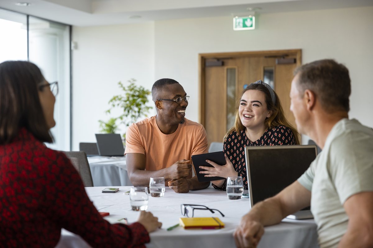 Accountants discussing a client file in a small practice