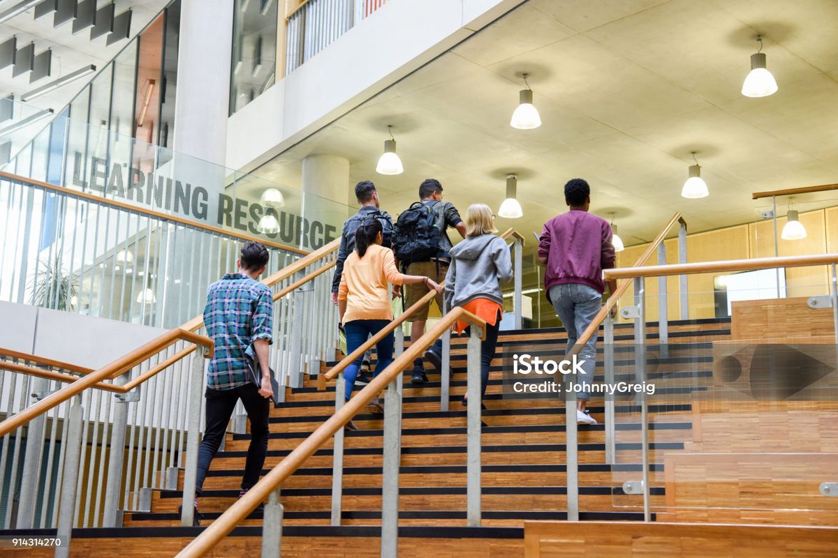 Students on the stairs of a modern city college building